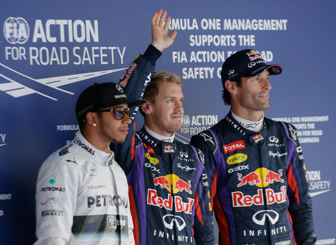 Red Bull driver Sebastian Vettel,centre, of Germany waves to the crowd after qualifying in pole position at the Korean Formula One Grand Prix at the Korean International Circuit in Yeongam, South Korea, Saturday, Oct. 5, 2013. Mercedes driver Lewis H